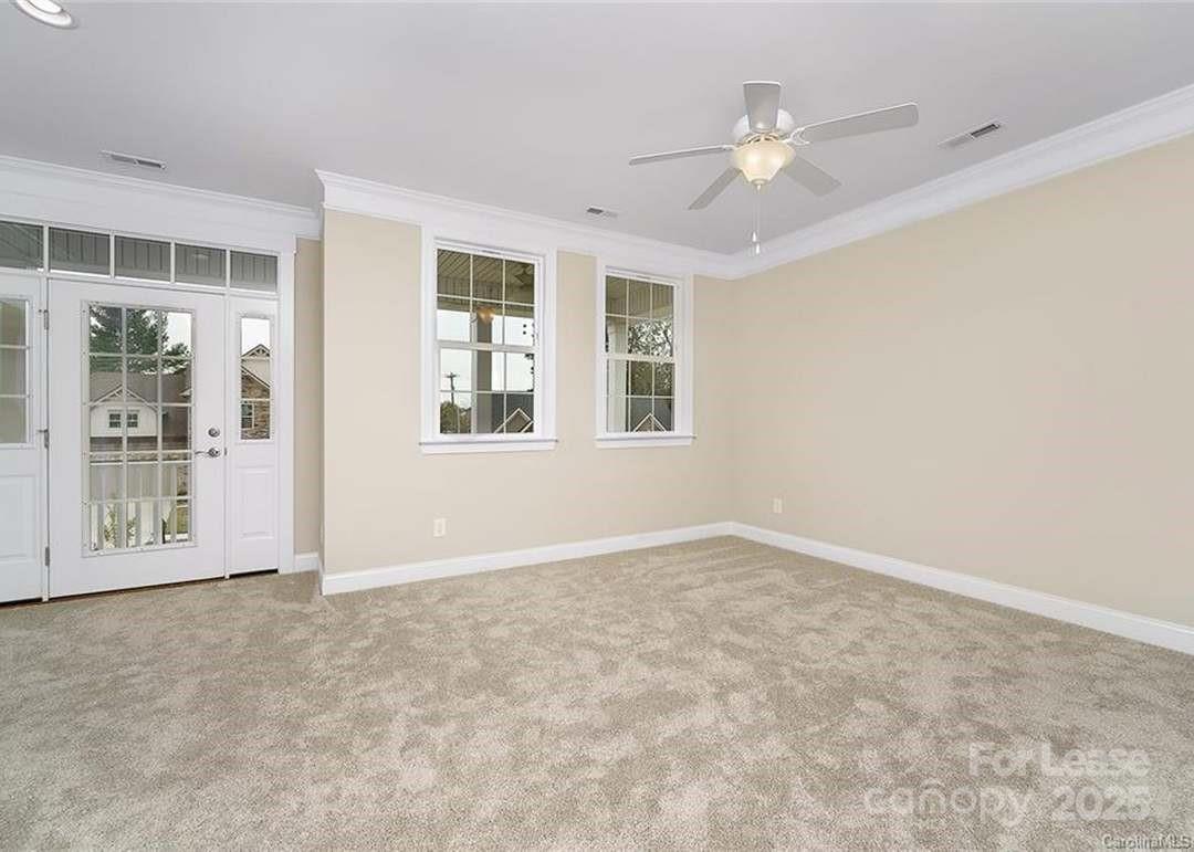 13012 Vermillion Crossing Court Huntersville, NC 28078 - Photo 14 of 18 an empty room with windows and ceiling fan
