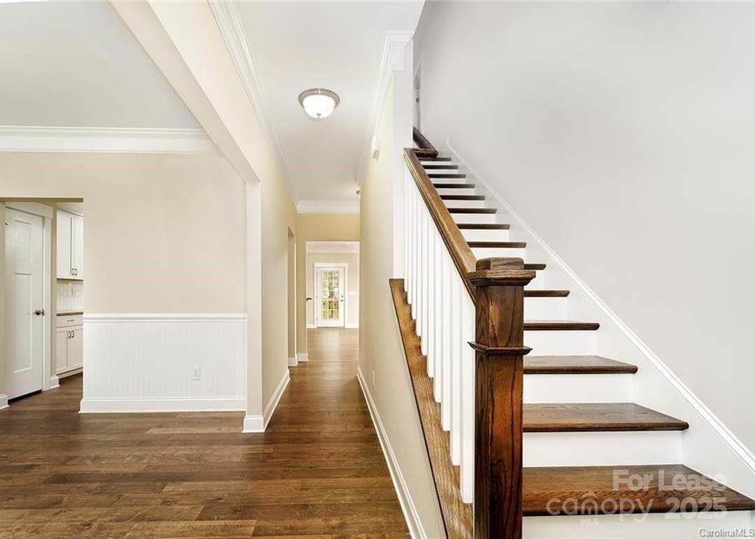 13012 Vermillion Crossing Court Huntersville, NC 28078 - Photo 3 of 18 a view of a hallway with wooden floor and staircase