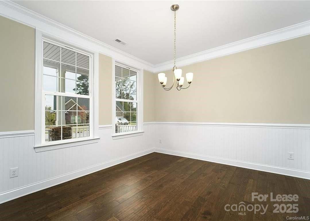 13012 Vermillion Crossing Court Huntersville, NC 28078 - Photo 4 of 18 a view of empty room with wooden floor and fan