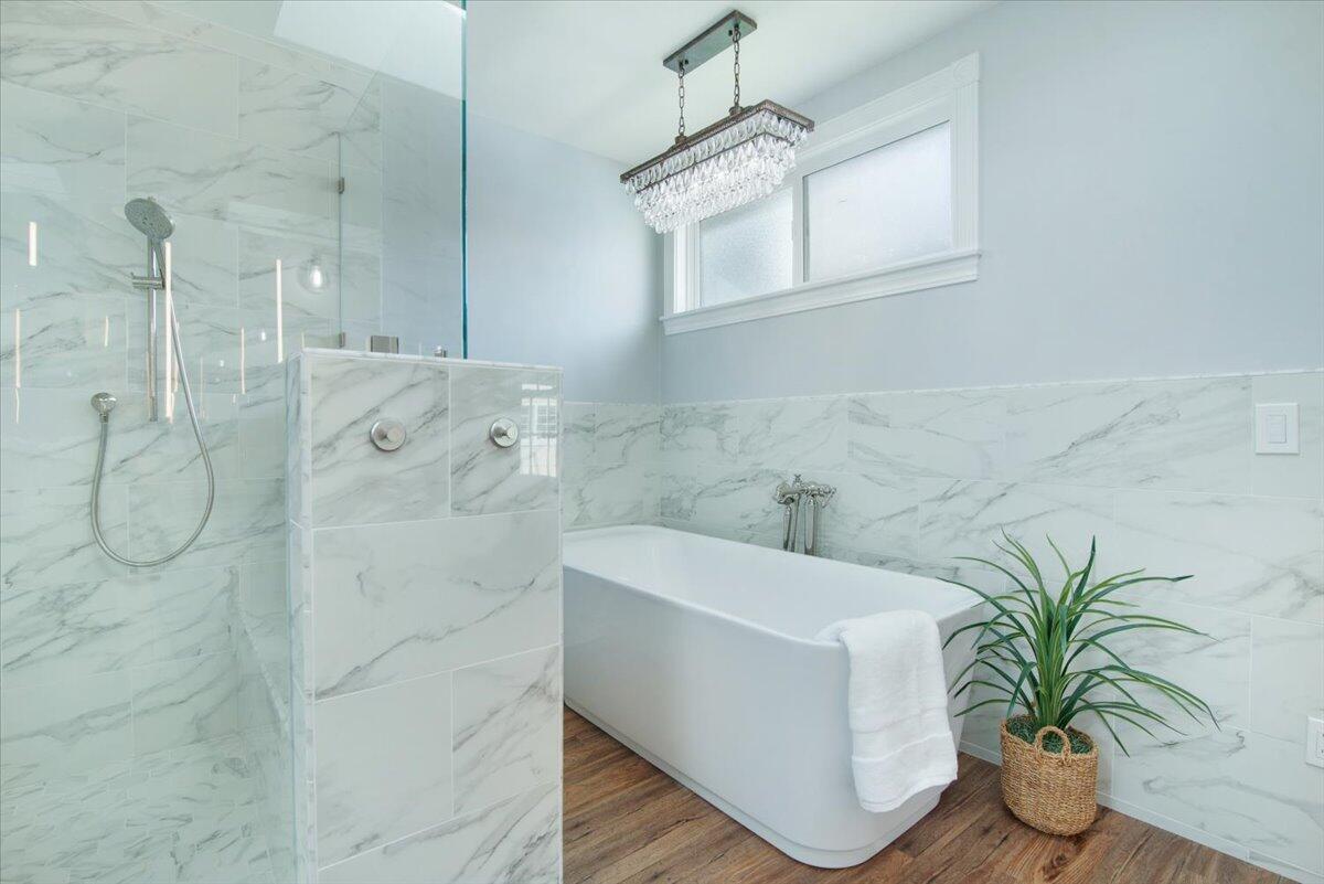 403 South M Street Lompoc, CA 93436 - Photo 19 of 32 a white bath tub sitting in a bathroom and mirror