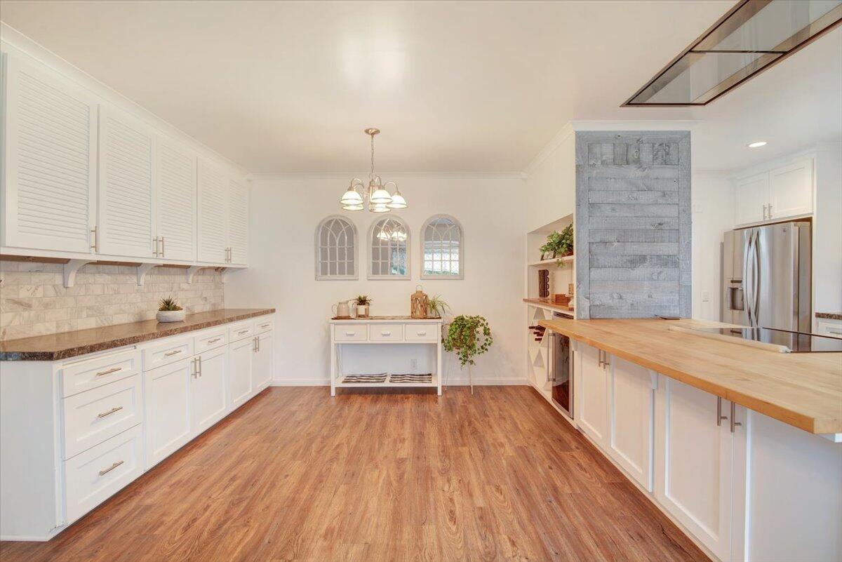 403 South M Street Lompoc, CA 93436 - Photo 5 of 32 a large kitchen with kitchen island a white counter space a sink stainless steel appliances and cabinets