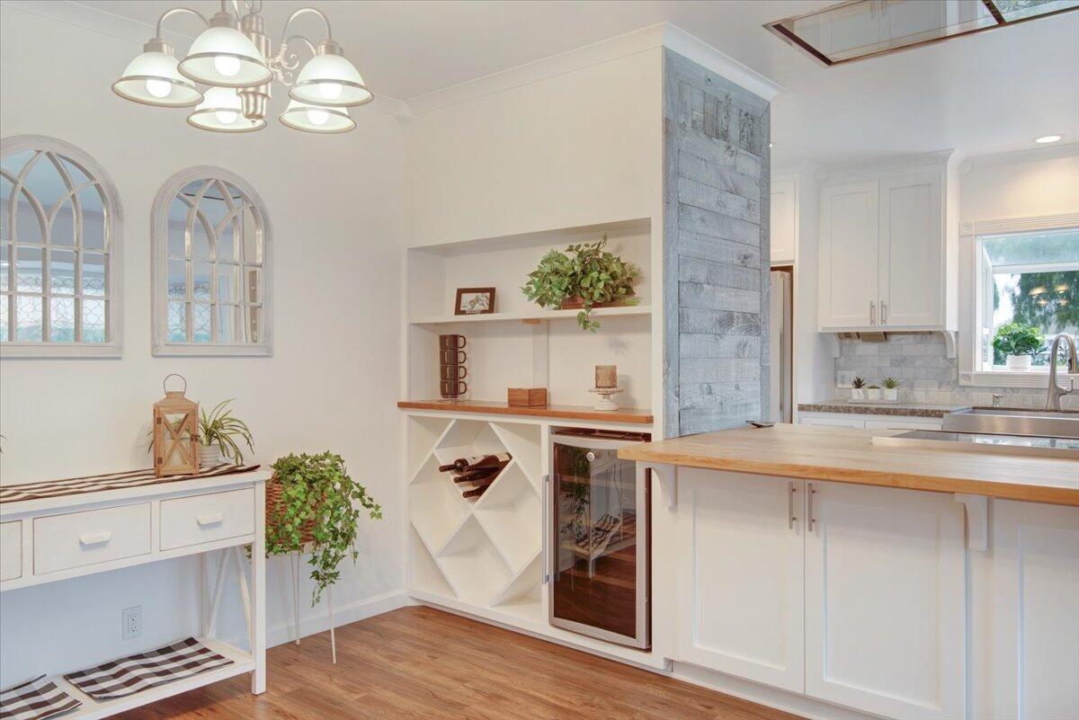 403 South M Street Lompoc, CA 93436 - Photo 7 of 32 a view of a kitchen with a sink wooden floor and chandelier