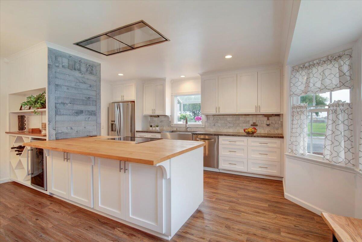 403 South M Street Lompoc, CA 93436 - Photo 8 of 32 a kitchen with stainless steel appliances granite countertop a sink stove and refrigerator