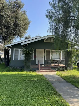 a view of a house with a yard porch and sitting area