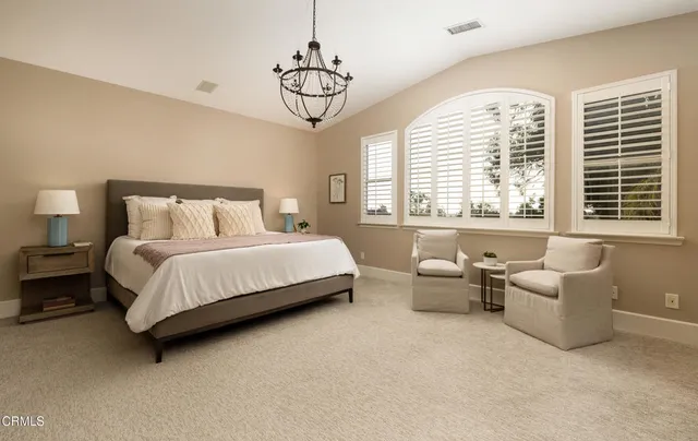 a bedroom with bed and windows