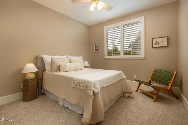 a bedroom with a bed chair and a window
