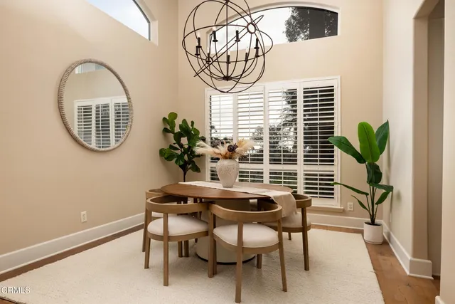 a view of a dining room with furniture and a potted plant
