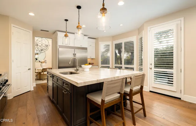 a kitchen with stainless steel appliances granite countertop a stove and a refrigerator