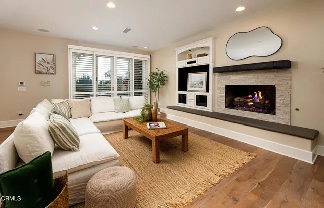 a living room with furniture couches and a fireplace