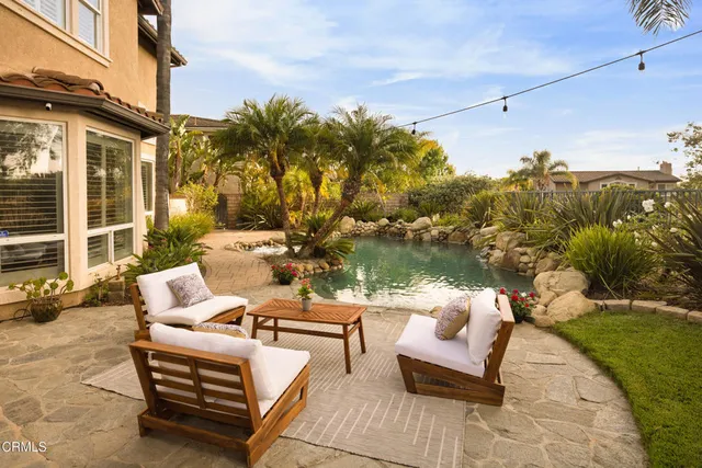 a view of a patio with couches and pool