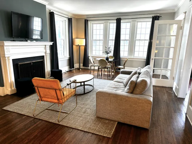a living room with fireplace furniture and a flat screen tv
