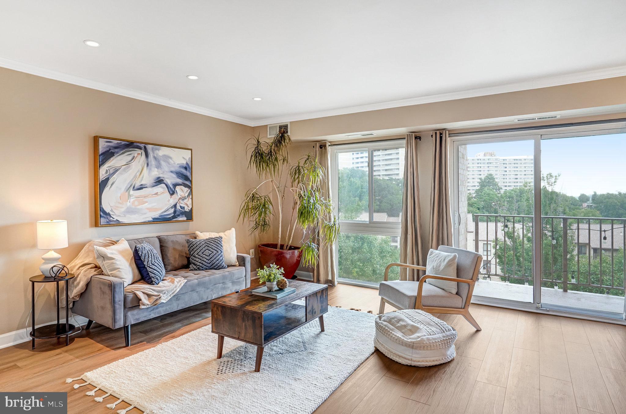 6143 Edsall Road, Unit J Alexandria, VA 22304 - Photo 1 of 23 a living room with furniture and a large window