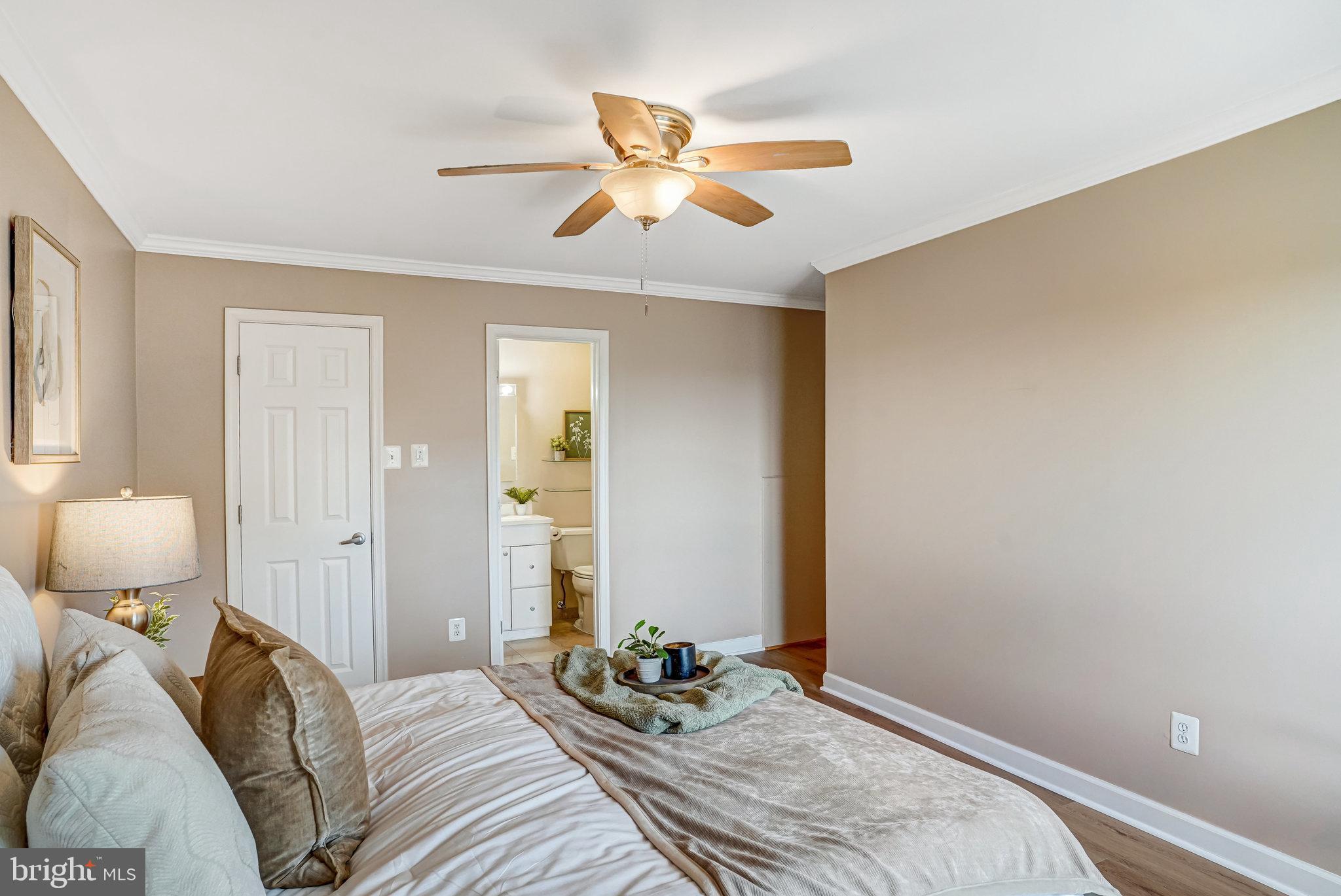 6143 Edsall Road, Unit J Alexandria, VA 22304 - Photo 10 of 23 a bedroom with a bed and a chandelier