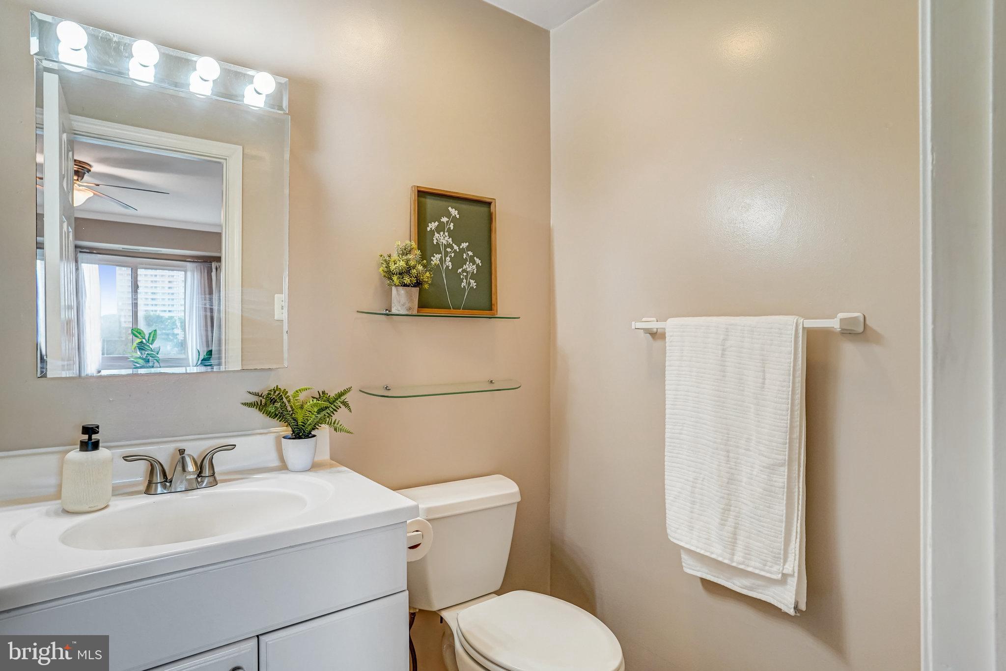 6143 Edsall Road, Unit J Alexandria, VA 22304 - Photo 12 of 23 a bathroom with a toilet sink and mirror