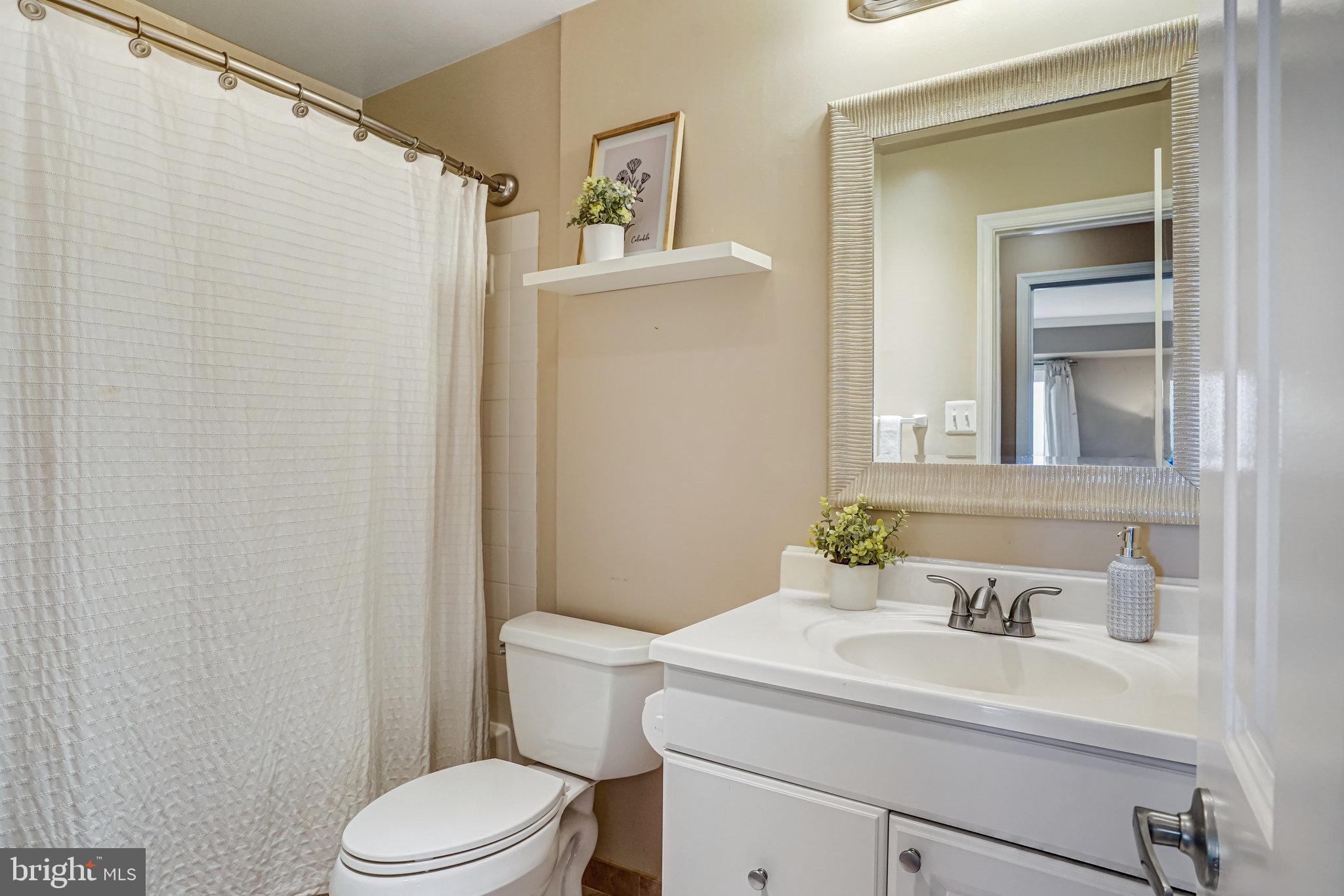 6143 Edsall Road, Unit J Alexandria, VA 22304 - Photo 15 of 23 a bathroom with a sink a toilet and shower