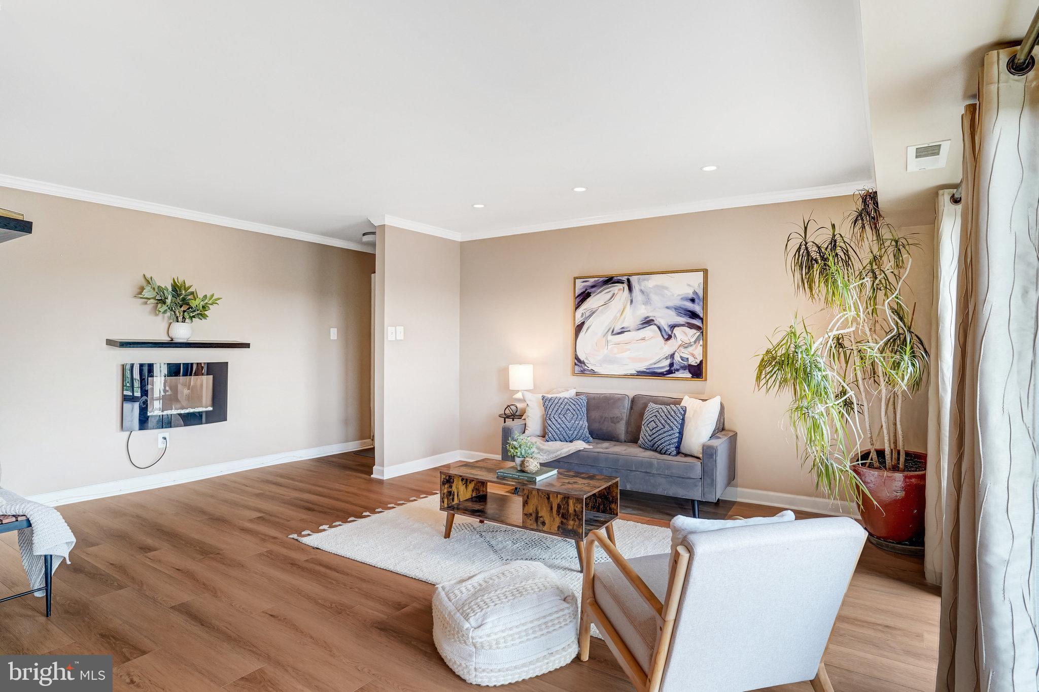 6143 Edsall Road, Unit J Alexandria, VA 22304 - Photo 3 of 23 a living room with furniture and a wooden floor
