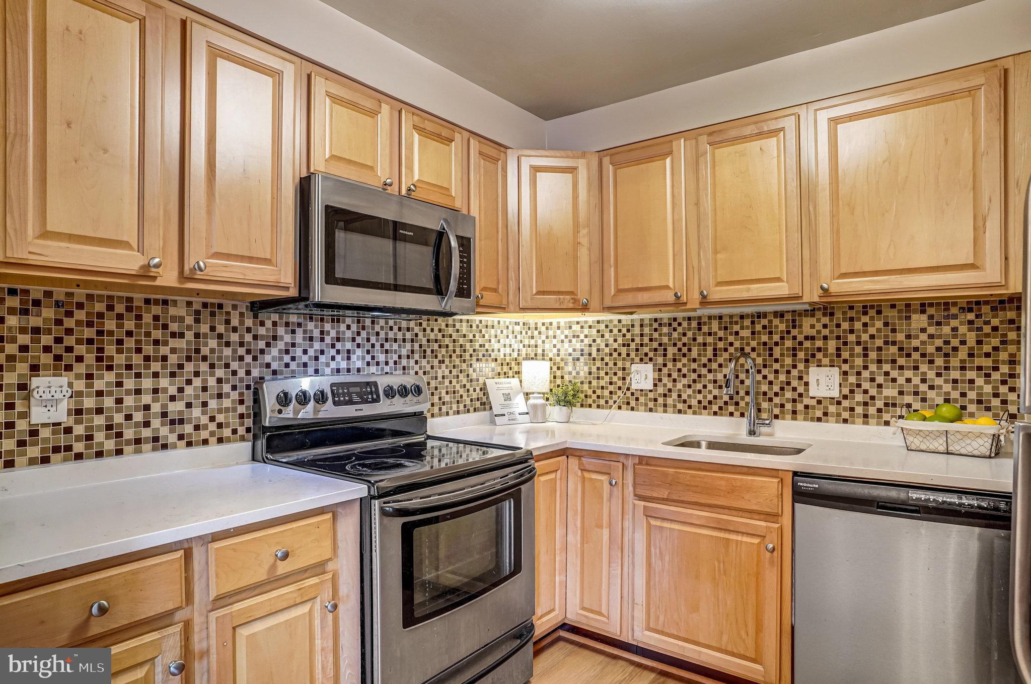 6143 Edsall Road, Unit J Alexandria, VA 22304 - Photo 7 of 23 a kitchen with a sink stove and cabinets