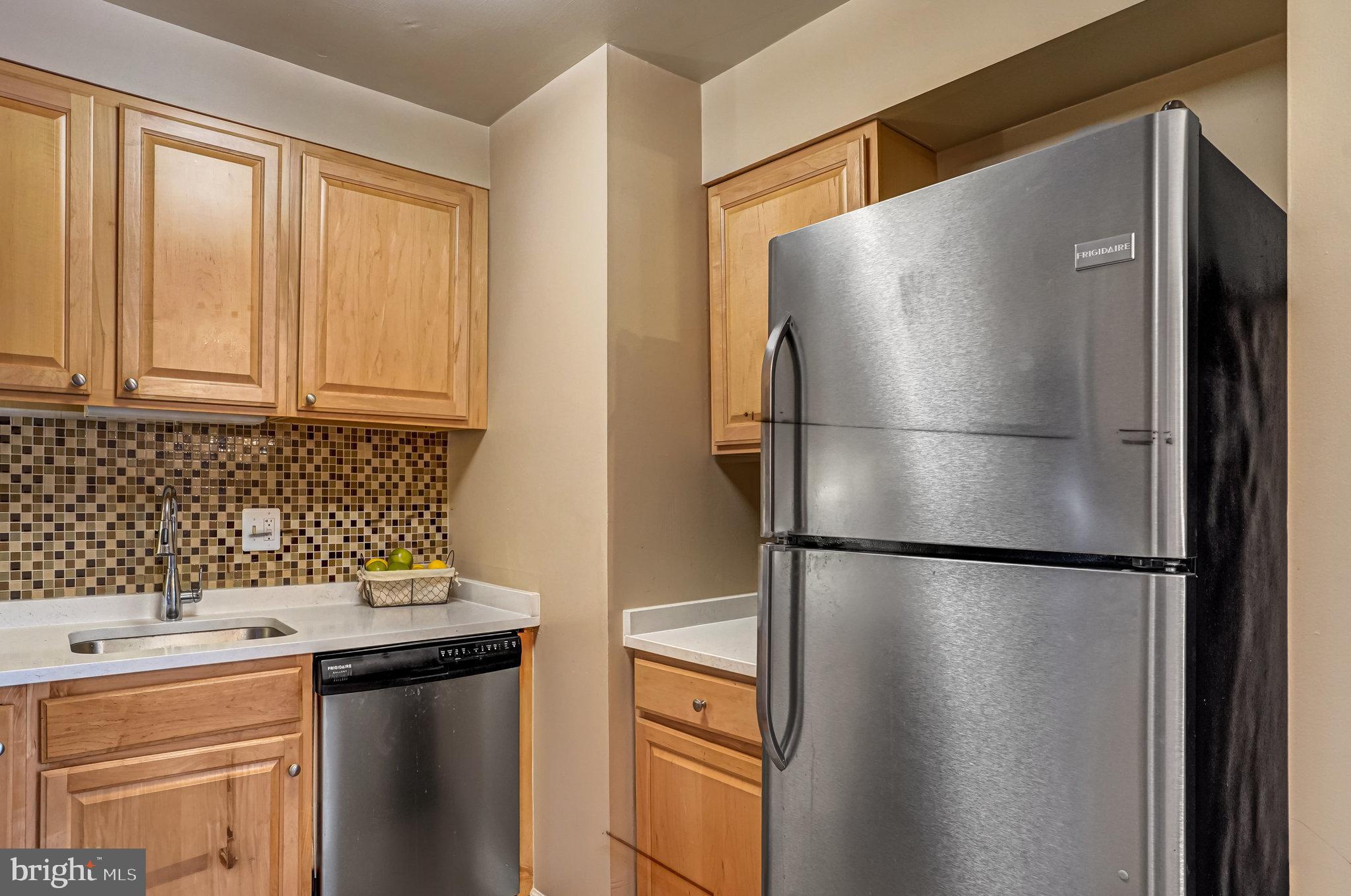 6143 Edsall Road, Unit J Alexandria, VA 22304 - Photo 8 of 23 a kitchen with stainless steel appliances granite countertop a refrigerator and a stove top oven