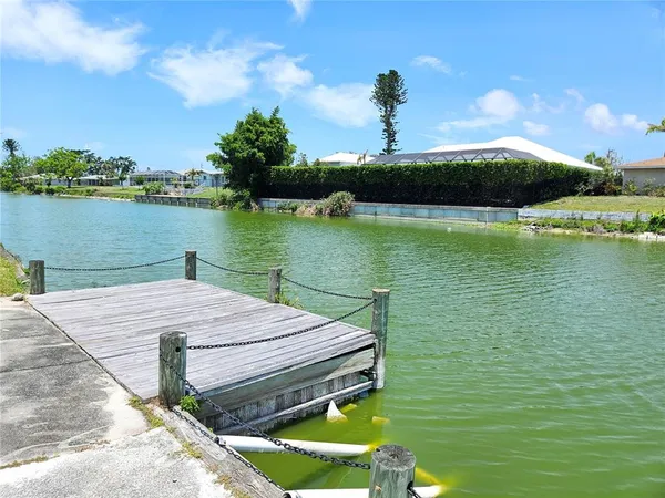 a view of a lake with houses in the back