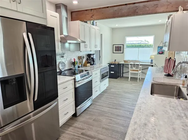 a kitchen with stainless steel appliances a refrigerator and a sink
