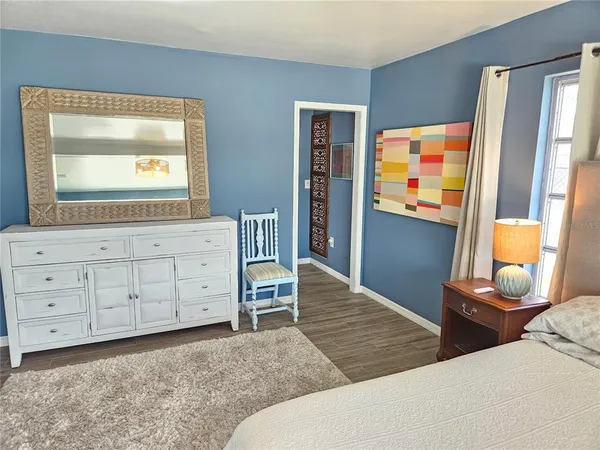 a bedroom with a bed and a dresser in it