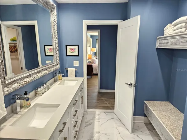 a bathroom with a tub sink and mirror