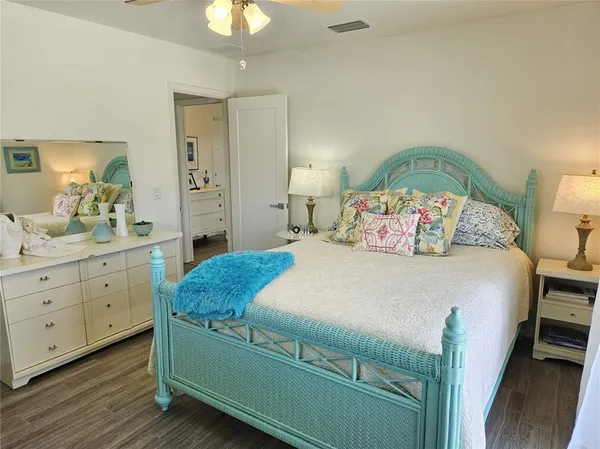 a bedroom with a bed and a chandelier