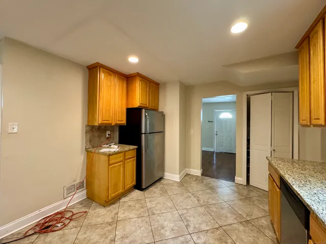a view of a kitchen with refrigerator and microwave