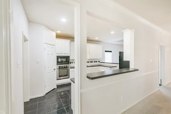 a kitchen with stainless steel appliances granite countertop a refrigerator and a stove