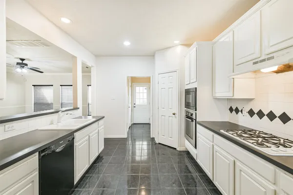 a kitchen with a sink stove and refrigerator