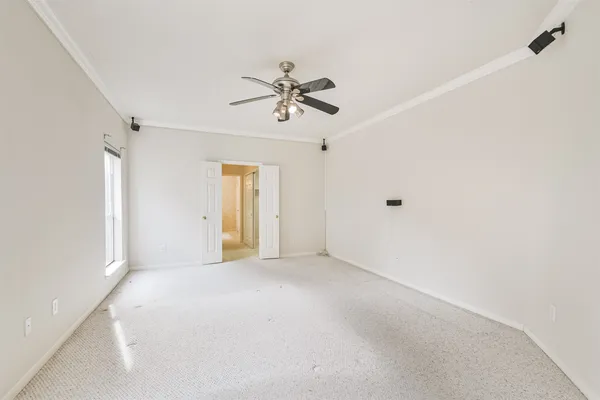 a view of a livingroom with a ceiling fan and carpet