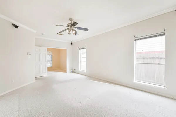 a view of a livingroom with a ceiling fan and window