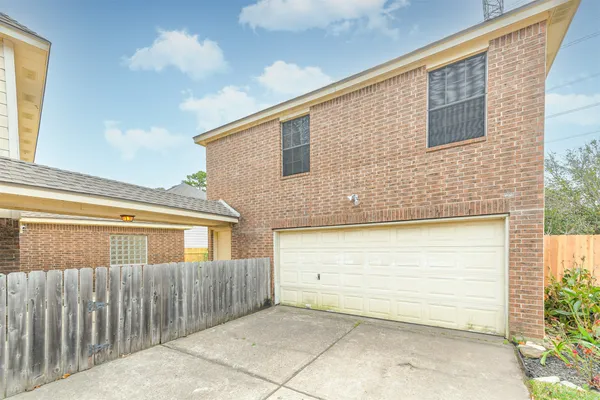 a view of a house with a wooden fence
