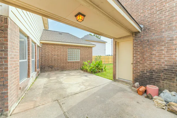 a view of a room that has a window and potted plants