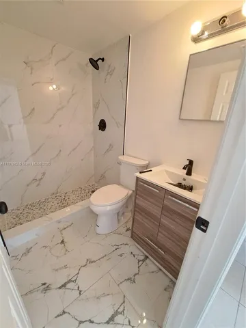 a bathroom with a sink toilet and shower