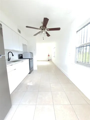 a kitchen with a sink a stove and cabinets