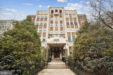 a front view of a building with a garden