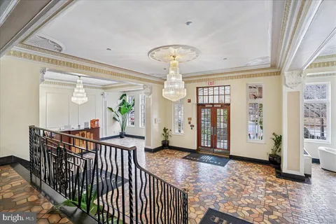 a view of a bedroom with wooden floor and windows