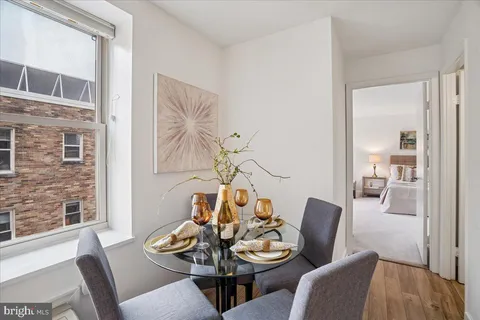 a dining room with furniture and wooden floor