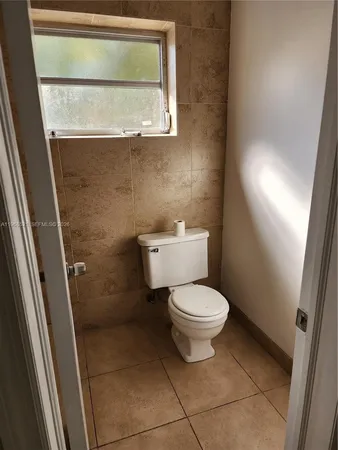 a view of a livingroom with an empty space and a window