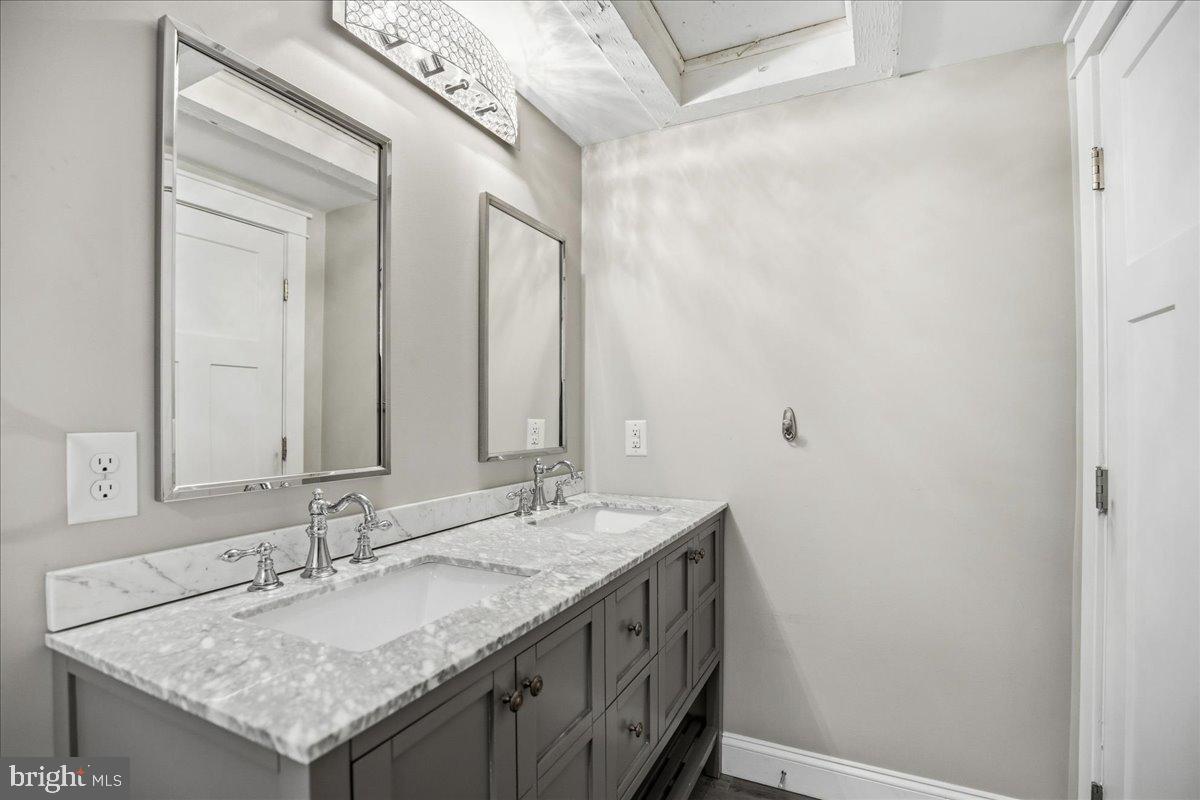 16146 Thomas Road Piney Point, MD 20674 - Photo 39 of 70 a bathroom with a granite countertop sink and a mirror