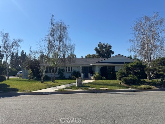 1200 West Rowan Street Anaheim, CA 92801 - Photo 1 of 20 a front view of a house with swimming pool and yard with green space