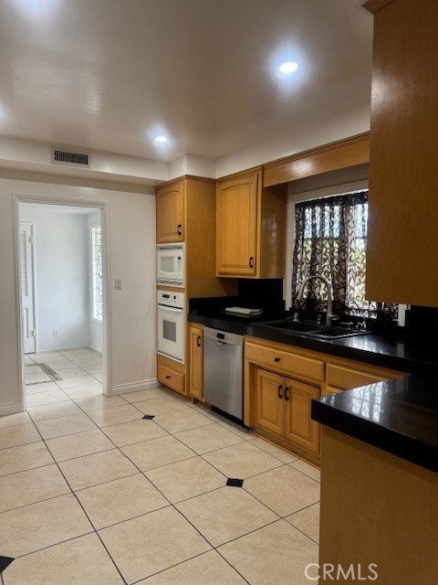 1200 West Rowan Street Anaheim, CA 92801 - Photo 19 of 20 a large kitchen with kitchen island granite countertop a sink and cabinets