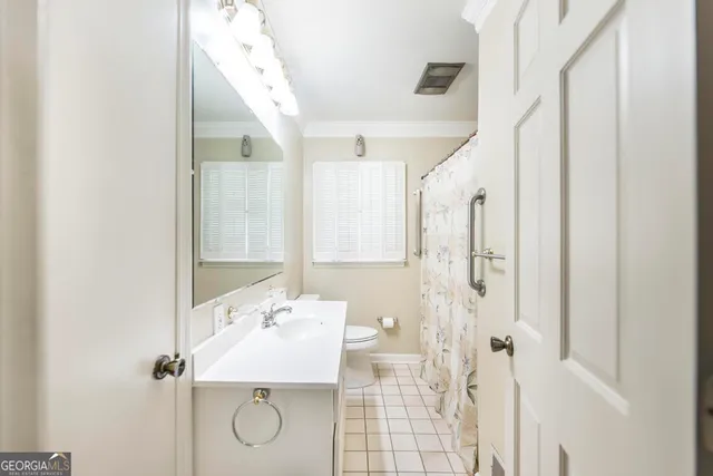 a bathroom with a granite countertop shower sink and mirror