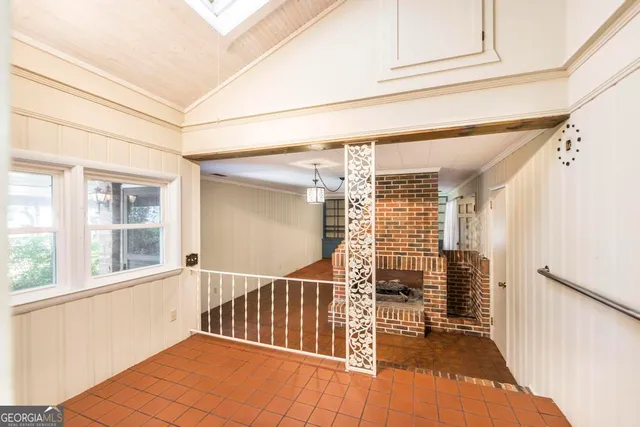 a view of a room with wooden floor and windows