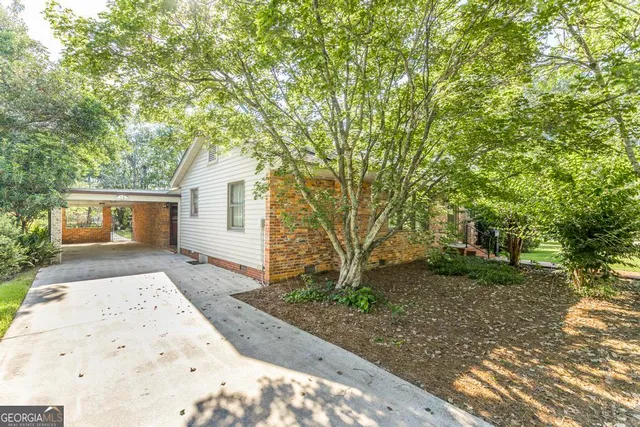a view of a house with a tree in the background