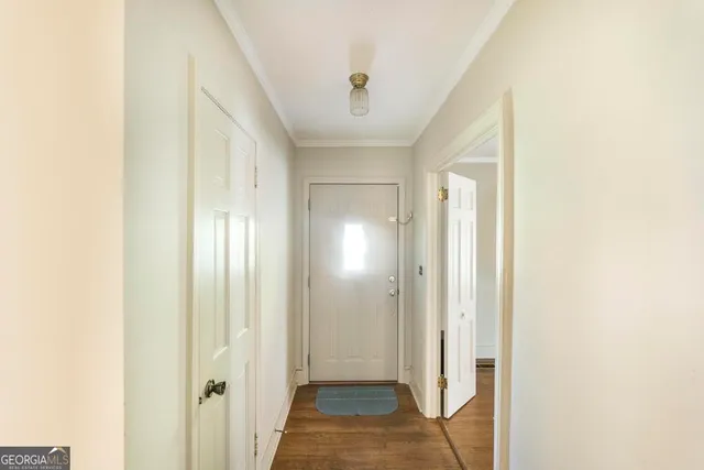 a view of a hallway with wooden floor
