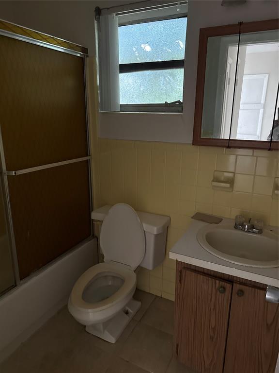 5925 Southwest 27th Street, Unit 1 West Park, FL 33023 - Photo 12 of 12 a bathroom with a toilet a sink and mirror