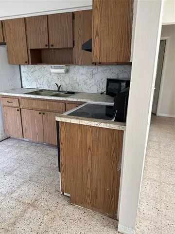 a kitchen with a sink and cabinets