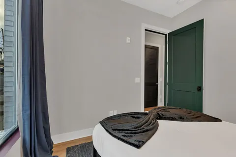 a bedroom with a bed and a window